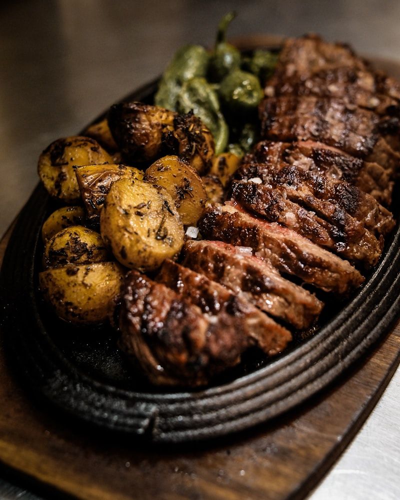 Grilled beef steak, sliced and served on a cast-iron platter